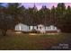Charming single-story home featuring white siding, a brick foundation, and a welcoming front porch with stair access at 1370 Poole Rd, Salisbury, NC 28146