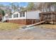 Charming single-story home with white siding, black shutters, accessible ramp, and a covered porch at 1370 Poole Rd, Salisbury, NC 28146
