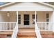 Inviting front porch with white railings, brick accents, and a screen door, enhancing the home's curb appeal at 1370 Poole Rd, Salisbury, NC 28146