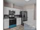 Close-up of kitchen with stainless steel appliances and ample cabinet space at 1370 Poole Rd, Salisbury, NC 28146