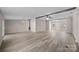 Spacious, airy living room featuring beam accents, large windows, and modern laminate flooring for a comfortable living space at 1370 Poole Rd, Salisbury, NC 28146
