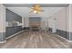 Bright living room featuring a stone fireplace, ceiling fan, and modern flooring at 1370 Poole Rd, Salisbury, NC 28146