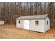 Storage shed with white siding, a gray roof, double doors, and a small window at 1370 Poole Rd, Salisbury, NC 28146