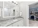Bright bathroom featuring single sink vanity with granite countertop and custom white cabinetry at 14701 Jockeys Ridge Dr, Charlotte, NC 28277