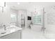Bright bathroom featuring marble countertops, a soaking tub, walk-in shower, and neutral decor at 14701 Jockeys Ridge Dr, Charlotte, NC 28277