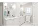 Bright bathroom featuring double sink vanity with marble countertop and custom white cabinetry at 14701 Jockeys Ridge Dr, Charlotte, NC 28277