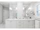 Bright bathroom featuring double sink vanity with marble countertop and custom white cabinetry at 14701 Jockeys Ridge Dr, Charlotte, NC 28277