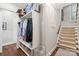 Organized closet adjacent to carpeted stairs with built-in shelving and wood flooring at 14701 Jockeys Ridge Dr, Charlotte, NC 28277