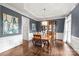 Elegant dining room with hardwood floors, wainscoting, stylish lighting, and beautiful china cabinet at 14701 Jockeys Ridge Dr, Charlotte, NC 28277