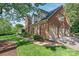 Traditional brick home featuring a 3-car garage, dormer windows and mature landscaping at 14701 Jockeys Ridge Dr, Charlotte, NC 28277