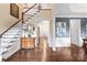 Spacious foyer with hardwood floors, staircase, elegant chest and views to dining and living areas at 14701 Jockeys Ridge Dr, Charlotte, NC 28277