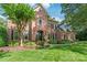 Beautiful brick home featuring manicured landscaping, a stately front entrance, and black shutters at 14701 Jockeys Ridge Dr, Charlotte, NC 28277