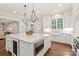 Spacious white kitchen with a large island, marble countertops, and stainless steel appliances at 14701 Jockeys Ridge Dr, Charlotte, NC 28277