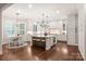 Open concept kitchen with an island, breakfast nook, custom cabinets, and stainless appliances at 14701 Jockeys Ridge Dr, Charlotte, NC 28277