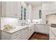 Bright kitchen features white cabinets, marble countertops, and a farm sink at 14701 Jockeys Ridge Dr, Charlotte, NC 28277