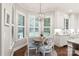 Sunlit breakfast nook with a round table and view of the backyard pool at 14701 Jockeys Ridge Dr, Charlotte, NC 28277