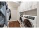 Well-organized laundry room with built-in storage and modern Electrolux washer and dryer at 14701 Jockeys Ridge Dr, Charlotte, NC 28277