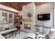 Cozy outdoor living area with a stone fireplace, built-in grill, and mini fridge for year-round enjoyment at 14701 Jockeys Ridge Dr, Charlotte, NC 28277