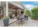 Luxurious outdoor patio with a stone fireplace, grilling area, and comfortable seating at 14701 Jockeys Ridge Dr, Charlotte, NC 28277