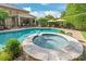 Gorgeous pool and spa with an outdoor entertaining area including lounge chairs and umbrellas at 14701 Jockeys Ridge Dr, Charlotte, NC 28277