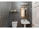 Chic powder room featuring patterned wallpaper, pedestal sink, and decorative gold mirror at 14701 Jockeys Ridge Dr, Charlotte, NC 28277
