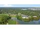 An aerial view shows a golf course, tennis courts, pool and neighborhood at 157 Dedham Loop, Mooresville, NC 28117