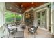 Enclosed back porch with wood ceiling, stone accents, and screened windows at 157 Dedham Loop, Mooresville, NC 28117