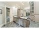 Bathroom with double sinks, granite counters, custom cabinets, and tile flooring at 157 Dedham Loop, Mooresville, NC 28117