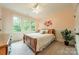 Bright bedroom featuring three windows, carpet flooring, and a ceiling fan at 157 Dedham Loop, Mooresville, NC 28117