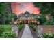 Beautiful home exterior featuring a manicured lawn, inviting front porch, and professionally landscaped walkway at 157 Dedham Loop, Mooresville, NC 28117