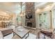 Open living room showcasing a stone fireplace, hardwood floors, and a view to the adjacent dining area at 157 Dedham Loop, Mooresville, NC 28117