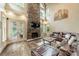 Spacious living room features a stone fireplace, hardwood floors, and a comfortable leather sectional sofa at 157 Dedham Loop, Mooresville, NC 28117