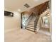 Hallway with staircase, wood paneled ceiling, and stone accent wall and wrought iron railing at 157 Dedham Loop, Mooresville, NC 28117