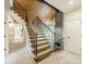 Staircase with wrought iron railing, wood steps, and a stone accent wall and wood paneled ceiling at 157 Dedham Loop, Mooresville, NC 28117