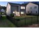 Backyard with a well manicured lawn, black metal fence and patio at 161 Old Harbor Dr, Mount Gilead, NC 27306