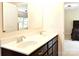 Elegant bathroom featuring a dual sink vanity, dark cabinetry, and modern fixtures at 161 Old Harbor Dr, Mount Gilead, NC 27306