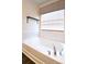 Relaxing bathtub area featuring tiled walls, chrome fixtures, and natural light at 161 Old Harbor Dr, Mount Gilead, NC 27306