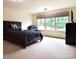 Spacious bedroom with large windows, plush carpet, and stylish furniture at 161 Old Harbor Dr, Mount Gilead, NC 27306