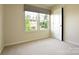 Bedroom featuring neutral carpeting and a large window at 161 Old Harbor Dr, Mount Gilead, NC 27306