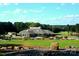 Beautiful clubhouse with golf course views and manicured landscaping on a sunny day at 161 Old Harbor Dr, Mount Gilead, NC 27306
