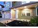 Inviting front porch adorned with charming American flags and landscape lighting for a warm welcome at 161 Old Harbor Dr, Mount Gilead, NC 27306