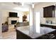 Open kitchen concept offering bar seating with a view of the fireplace and comfortable living room at 161 Old Harbor Dr, Mount Gilead, NC 27306