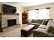 Cozy living room featuring a stone fireplace, comfortable seating, and abundant natural light at 161 Old Harbor Dr, Mount Gilead, NC 27306