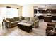 Open-concept living room showcasing hardwood floors, comfortable furniture, and seamless access to the kitchen at 161 Old Harbor Dr, Mount Gilead, NC 27306