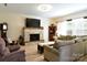 Bright living room boasts a stone fireplace, large TV, and comfortable seating for relaxation at 161 Old Harbor Dr, Mount Gilead, NC 27306
