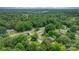 Aerial view of a residential area featuring a brick home surrounded by lush greenery and mature trees at 1753 28Th Ne St, Hickory, NC 28601