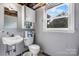 Basement half bathroom with sink, toilet, and cabinet at 1753 28Th Ne St, Hickory, NC 28601