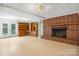 Finished basement featuring built-in bookcases, a brick fireplace, and a walk-out door at 1753 28Th Ne St, Hickory, NC 28601