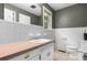Bathroom with white tile, a large mirror, a single window, and a single vanity sink at 1753 28Th Ne St, Hickory, NC 28601