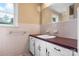Bright bathroom featuring retro wall tile, a single window, a large mirror, and vanity sink at 1753 28Th Ne St, Hickory, NC 28601